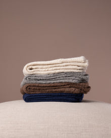 Stack of socks in various colours on a neutral background