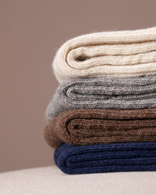 Stack socks in various colours on a neutral background