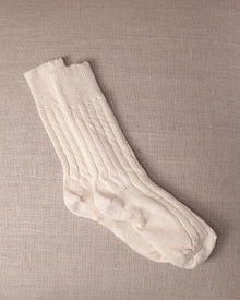 White socks on a beige textured background