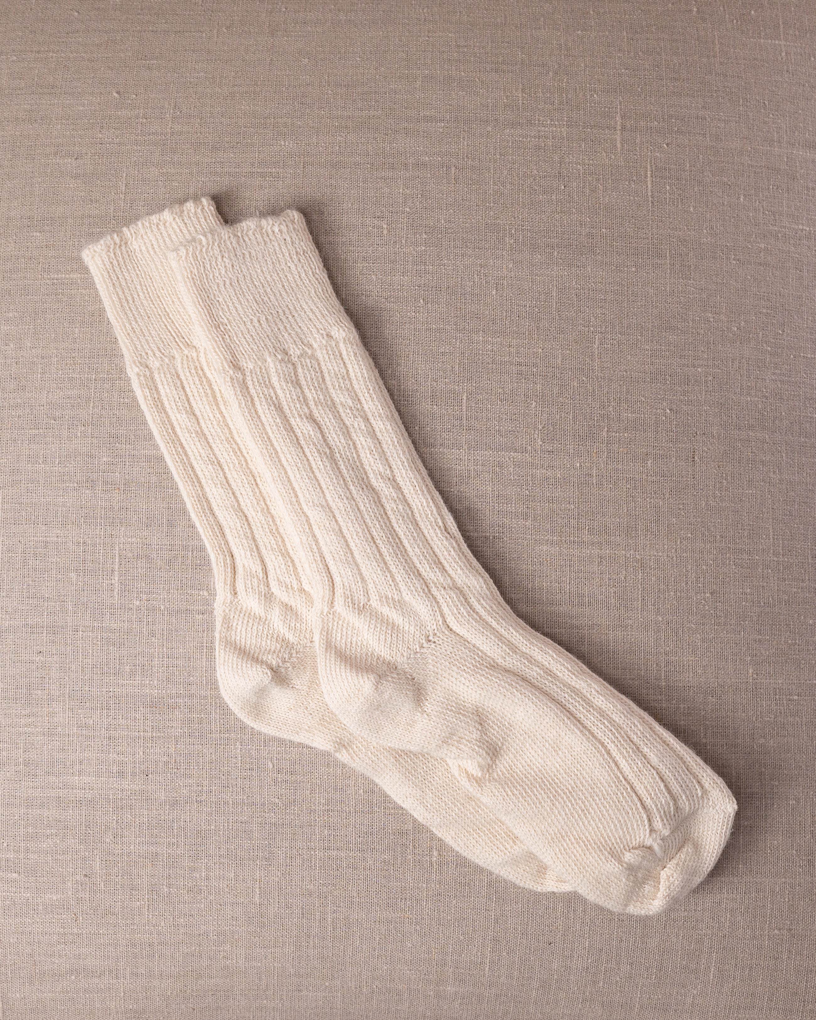 White socks on a beige textured background