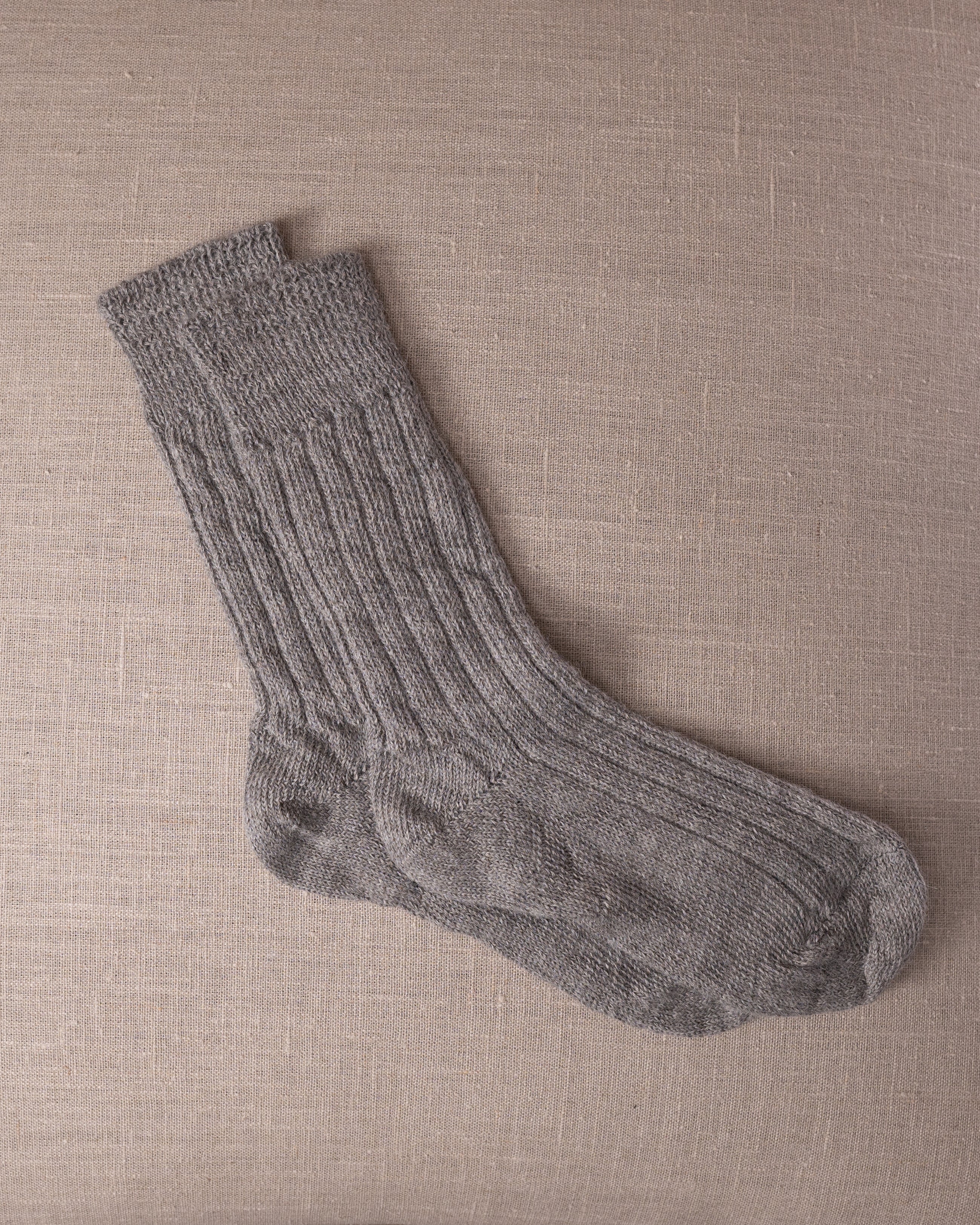 Gray socks on a beige textured background