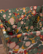 Close-up of a wastepaper bin covered with marbled paper