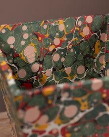 Close-up of a wastepaper bin covered with marbled paper