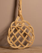 Carpet beater on a wooden surface with a brown background