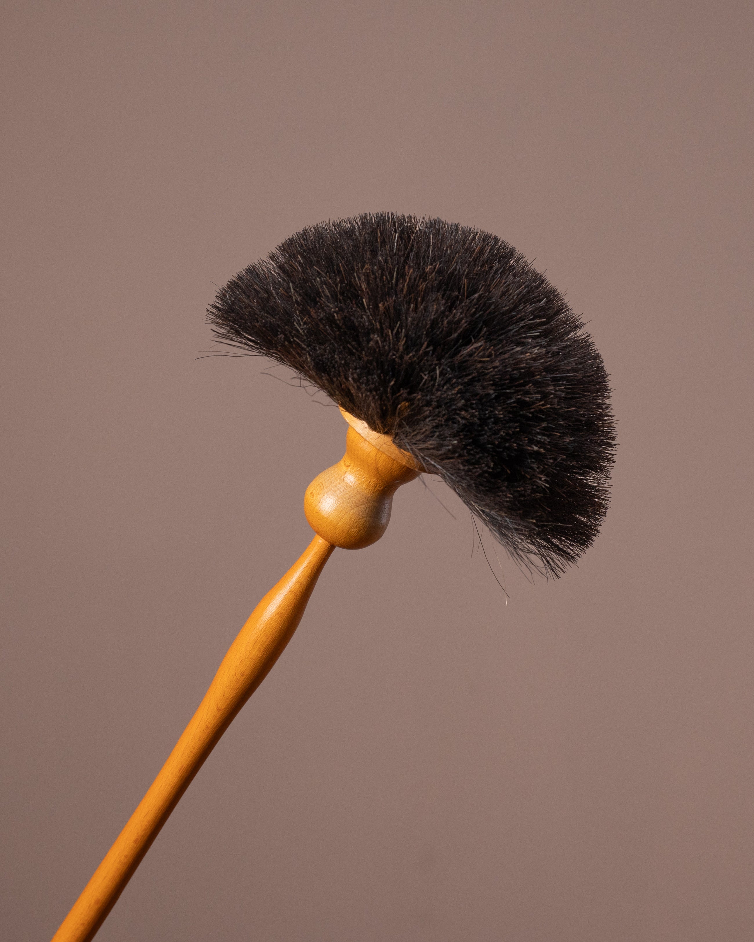 Small brush with black bristles on a brown background