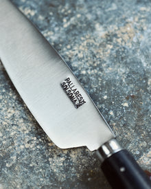 Knife with a brand logo on a textured surface
