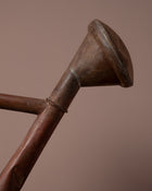 Close-up of a metal funnel with a brown background