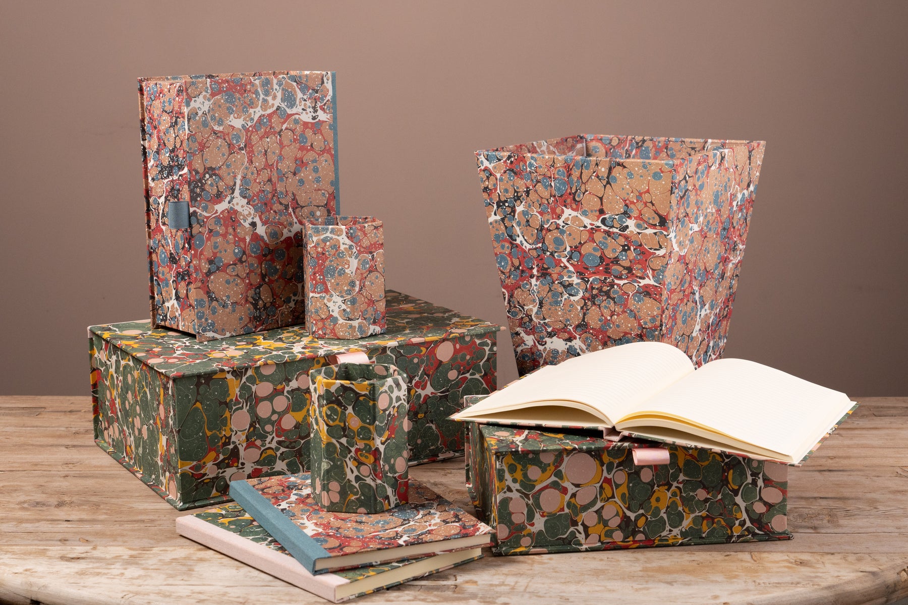 Selection of items covered in marbled paper on a wooden table top
