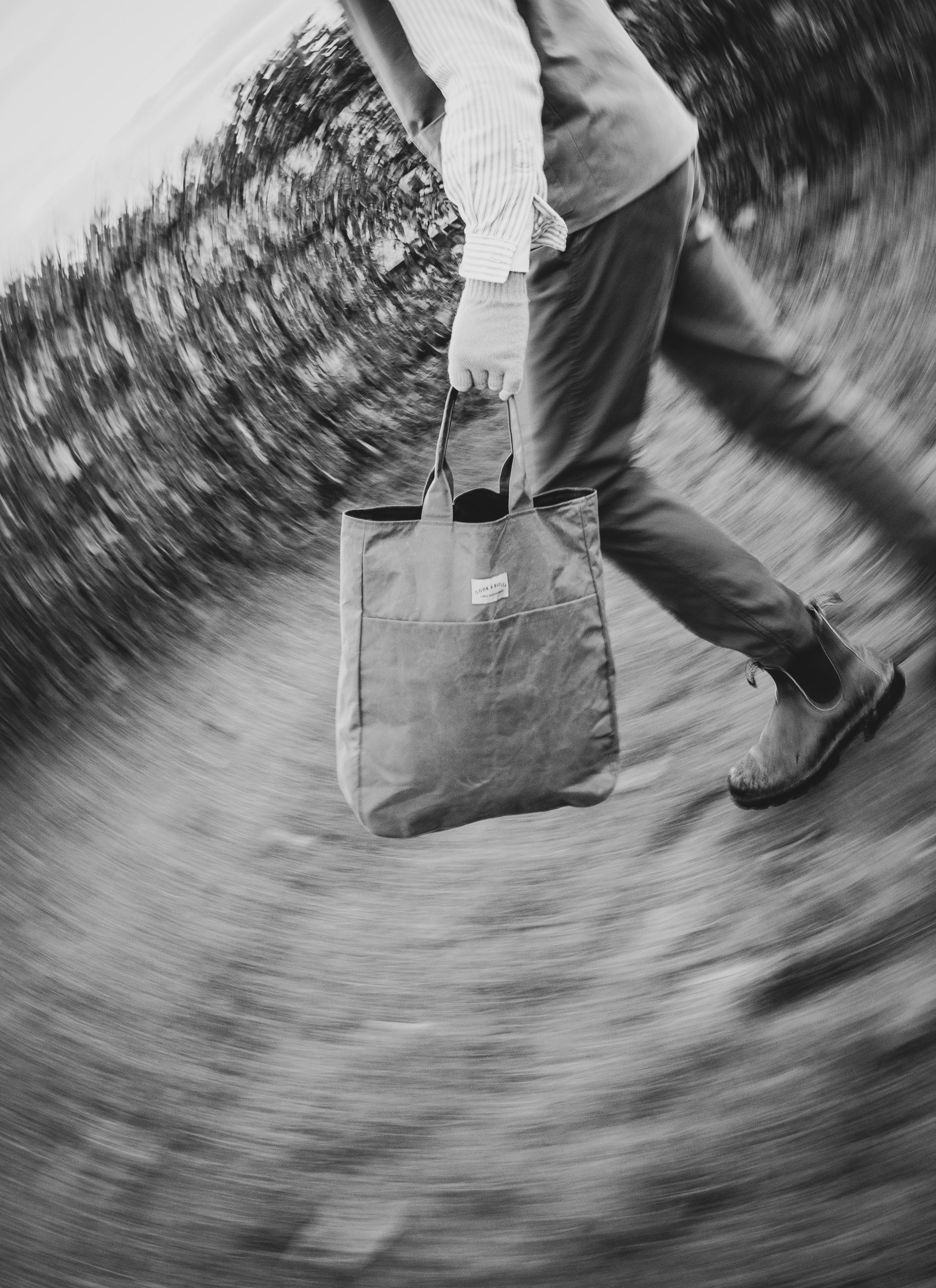 Person holding a tote bag with a blurry background