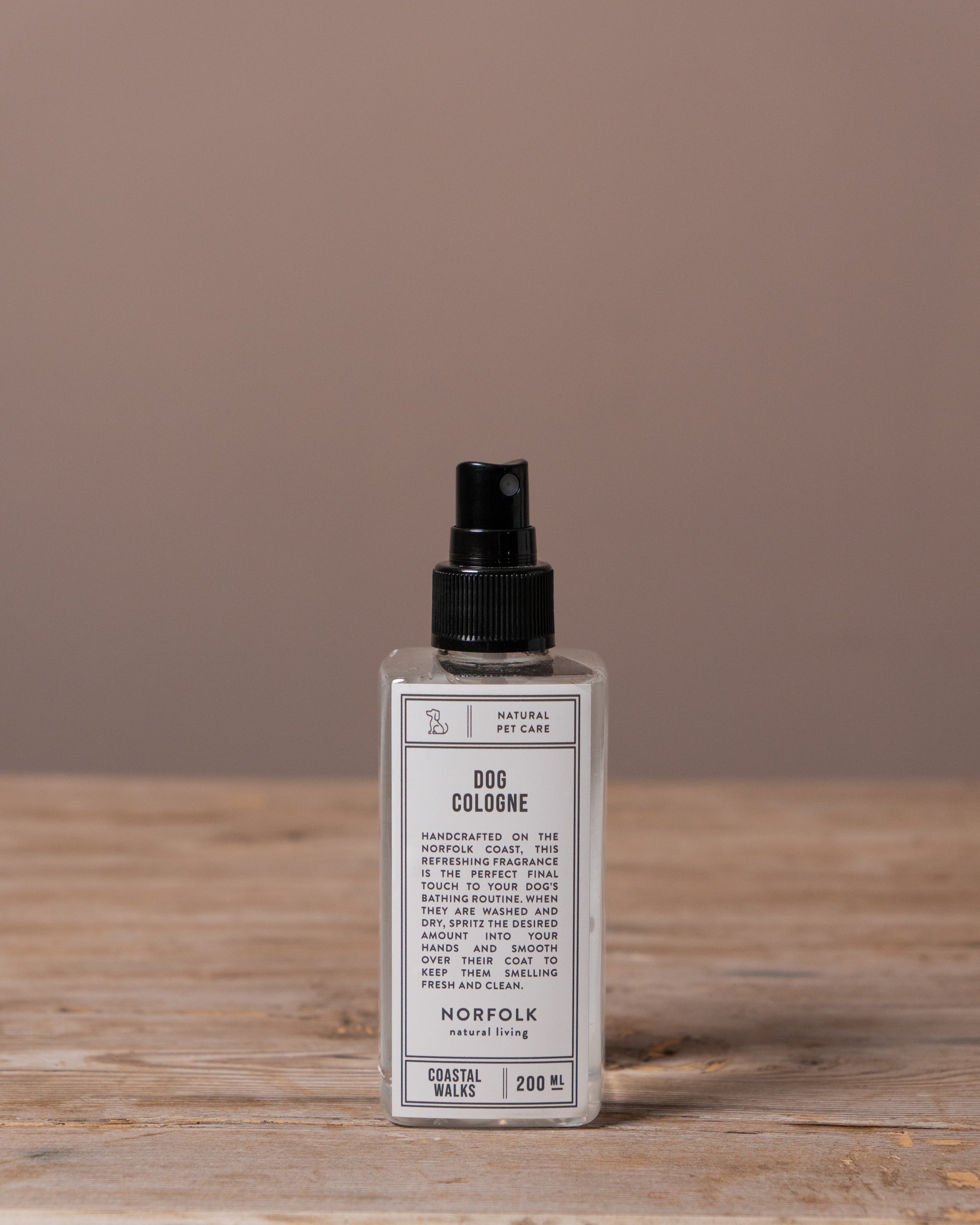 Dog cologne bottle on a wooden surface with a brown background