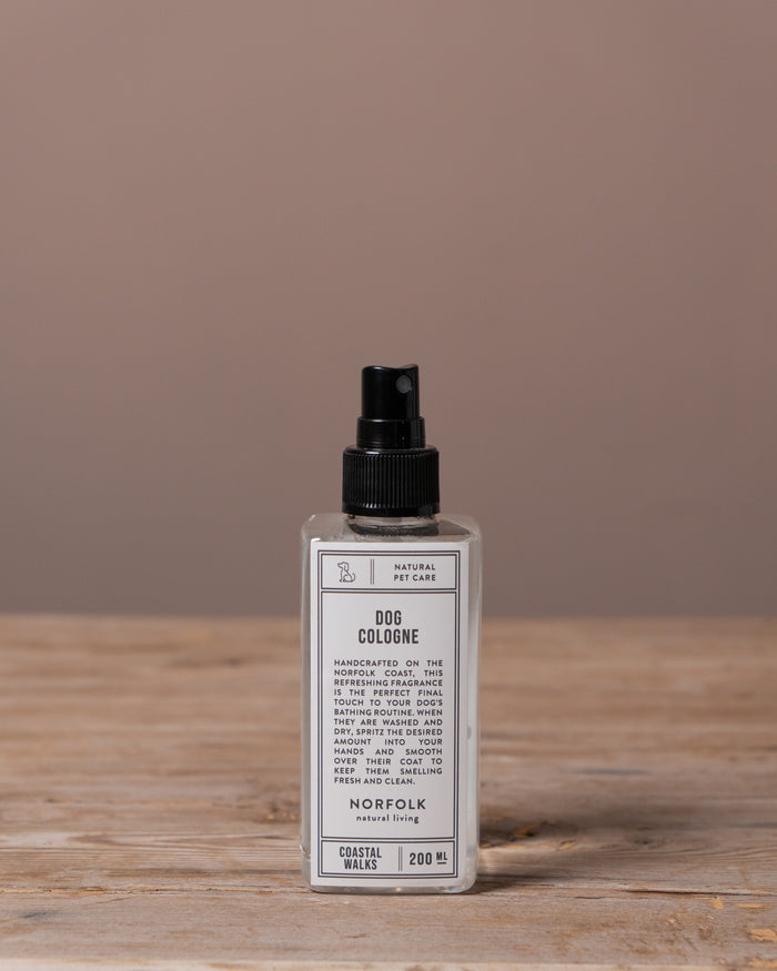 Dog cologne bottle on a wooden surface with a brown background