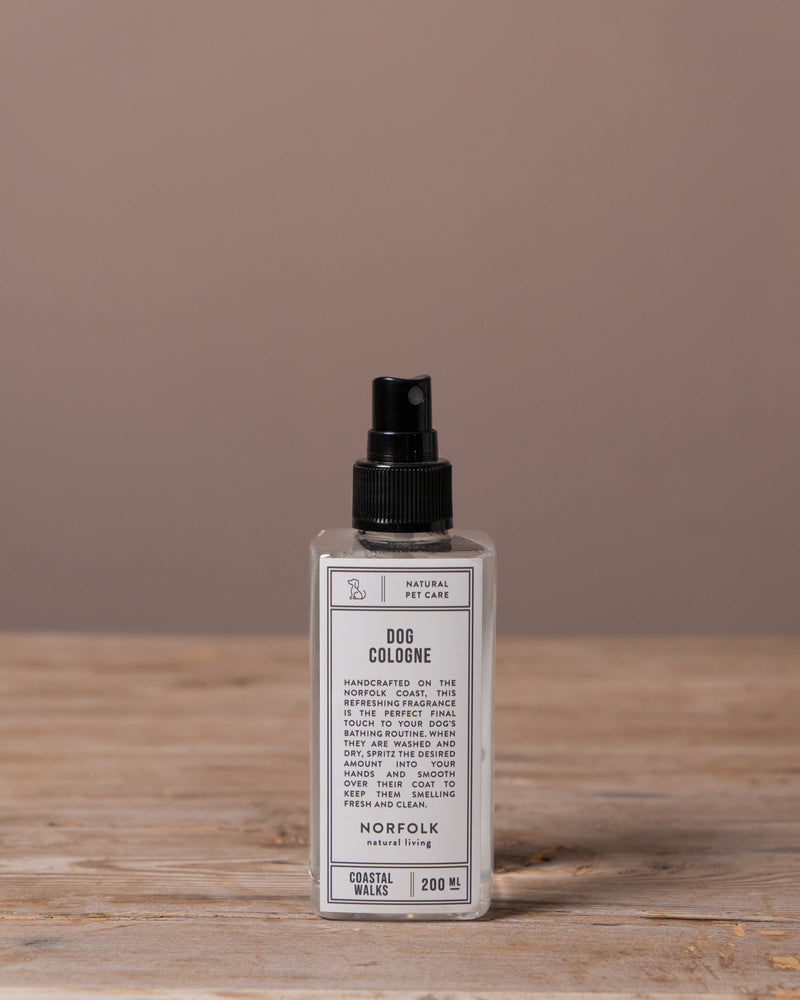 Dog cologne bottle on a wooden surface with a brown background