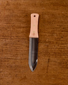 Niwaki Hori Hori garden knife on a wooden background