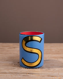 Painted brush pot with an S on the front