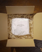 Panettone wrapped in white tissue paper and 'Cook & Butler' branding in a box