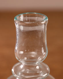 Clear glass shot glass on a brown surface