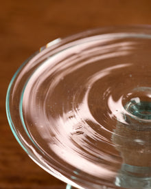 Close-up of a glass bowl with swirling pattern on a wooden surface