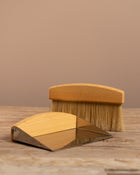Wooden brush and block set on a wooden surface with a beige background