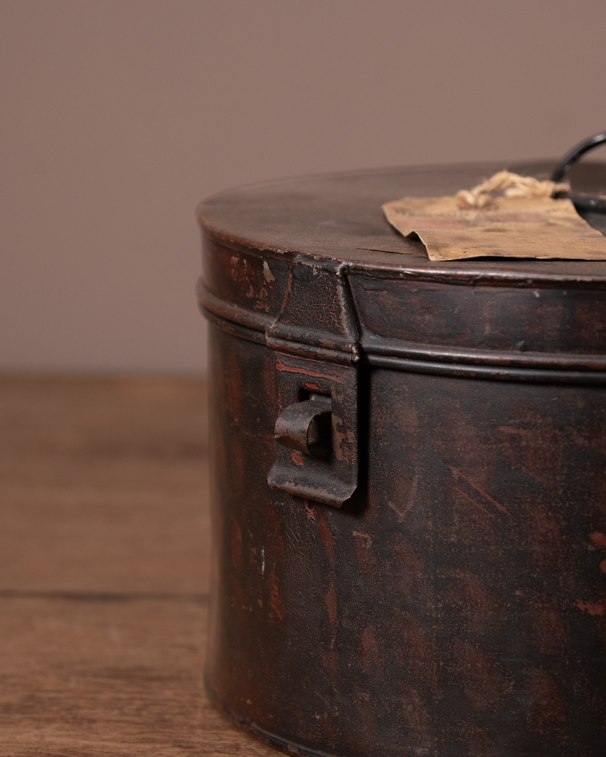Vintage metal canister with a lid on a wooden surface
