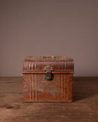 Vintage brown leather suitcase on a wooden surface with a plain background