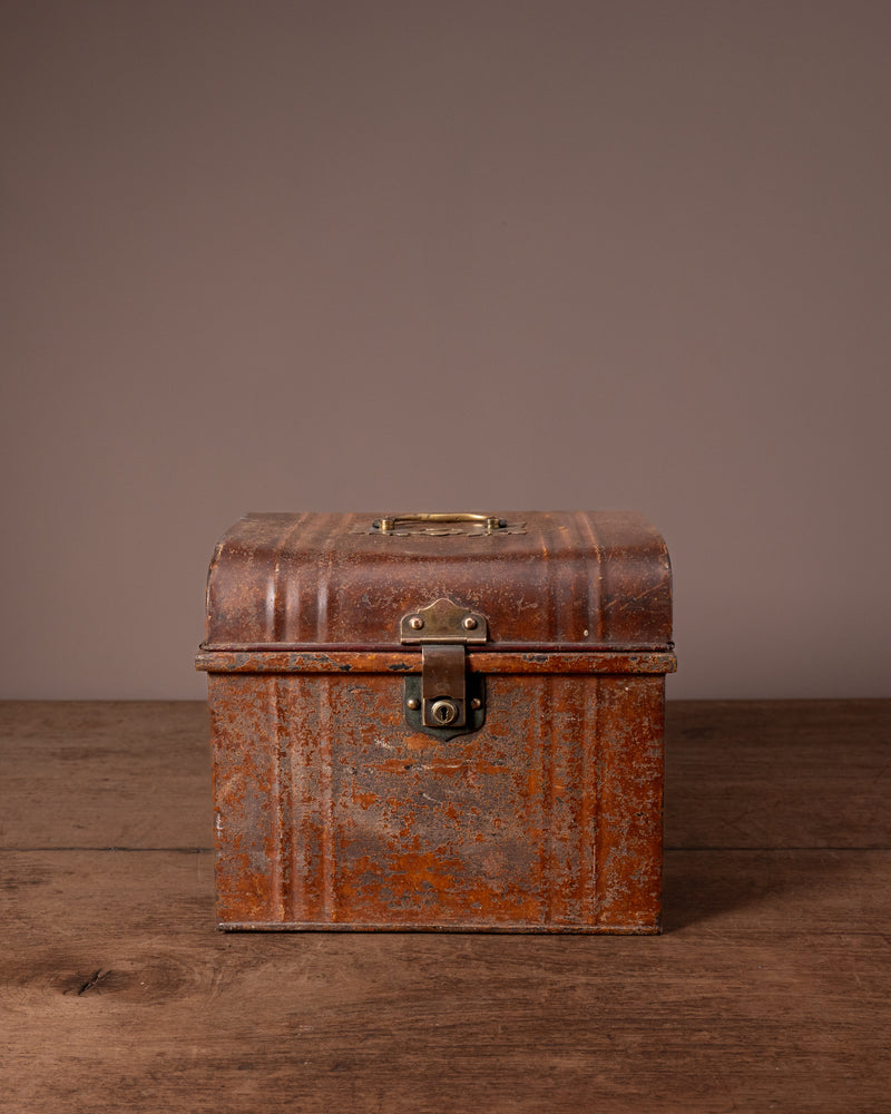 Vintage brown leather suitcase on a wooden surface with a plain background