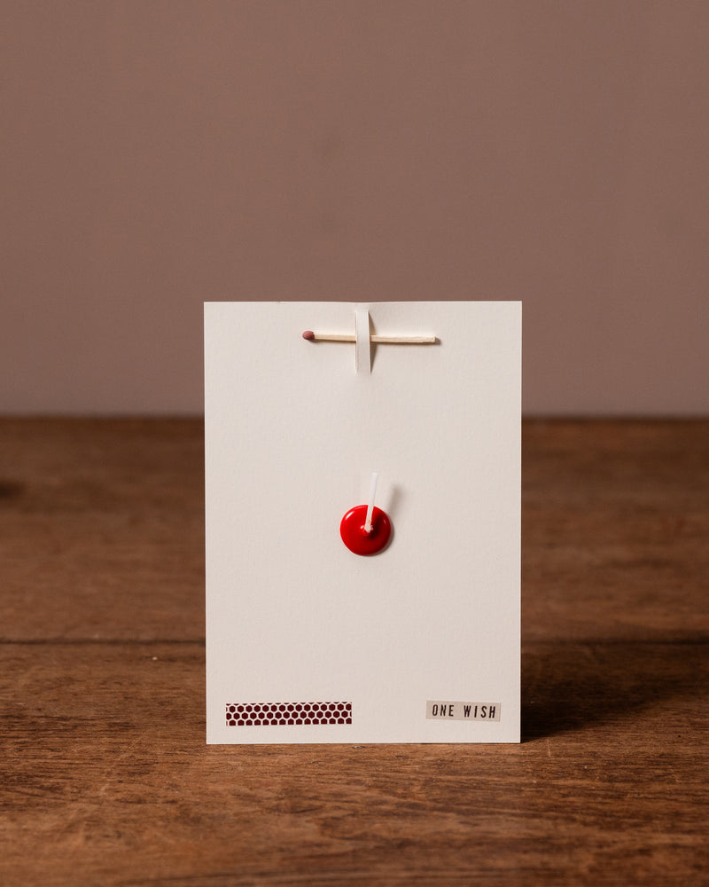 white card with 'One Wish' branding against a brown background