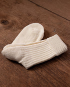 Pair of white socks on a wooden surface